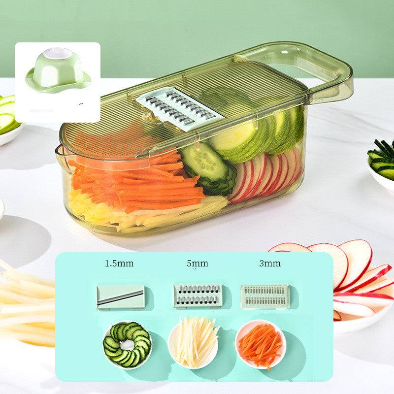 All-in-One Mandoline Slicer with clear plastic container, green handle, stainless steel blade, and sliced vegetables inside