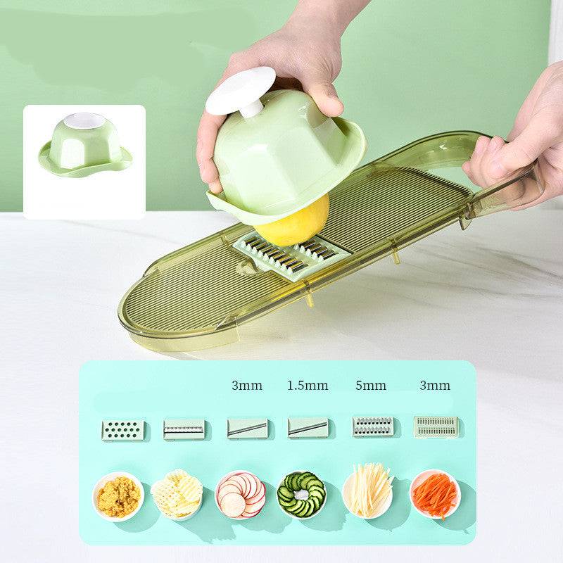 All-in-One Mandoline Slicer in light green with a hand protector slicing a lemon, showing six interchangeable stainless steel blades and sample cuts