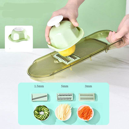All-in-One Mandoline Slicer with transparent yellow plastic frame and multiple stainless steel blades slicing a yellow vegetable using a green hand protector